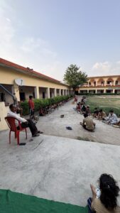 Bal Bhojan Seva Trust distributing nutritious meals to school children in the presence of the school principal.