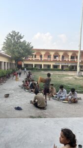Bal Bhojan Seva Trust distributing nutritious meals to school children in the presence of the school principal.
